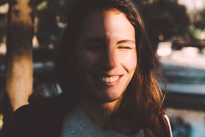 Close-up portrait of smiling young woman