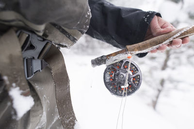 A fly fisherman's rod covered in ice.