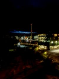 Illuminated buildings against sky at night