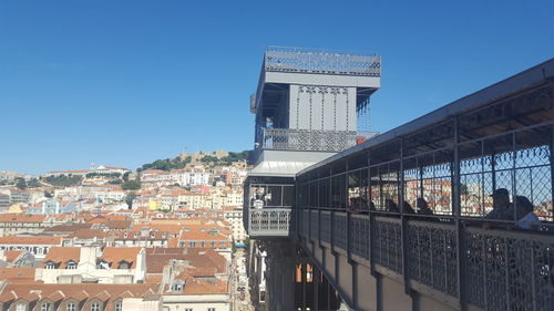 View of cityscape against clear blue sky