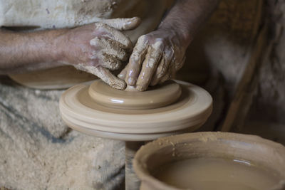 Man working on pottery wheel