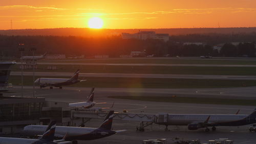 High angle view of airport runway against sky during sunset