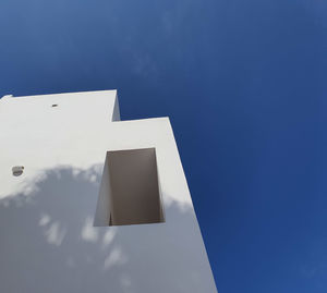 Low angle view of building against blue sky