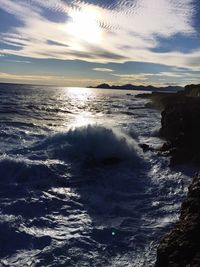 Scenic view of sea against cloudy sky
