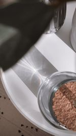 High angle view of coffee beans in glass on table