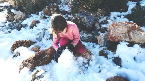 Full length of girl playing in snow