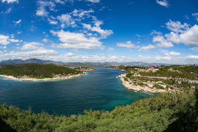 High angle view of townscape by sea against sky