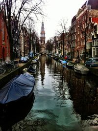 Boats in river with buildings in background