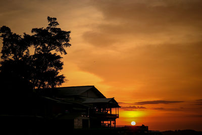 Silhouette buildings against sky during sunset