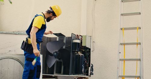 Side view of man working at construction site