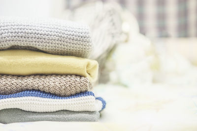 Woolen clothes stacked on table at home