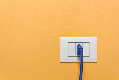 Close-up of telephone booth on wall