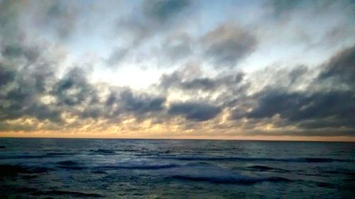 Scenic view of sea against cloudy sky