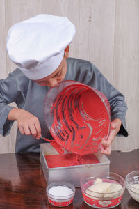 Boy preparing food on table at home