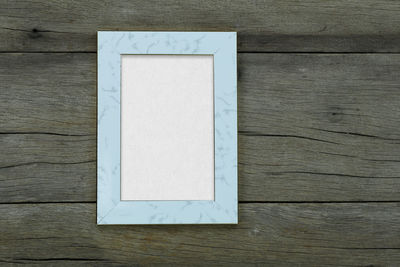 High angle view of white paper on wooden table
