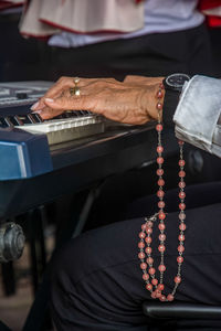 Midsection of man playing piano