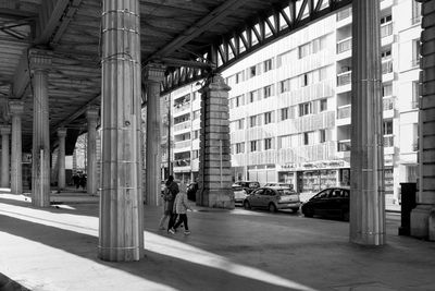 Man walking on street amidst buildings in city