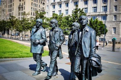 Statue of people walking in park