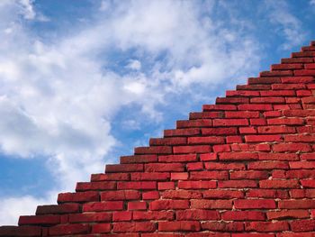 Low angle view of brick building against sky