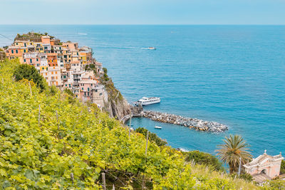 High angle view of townscape by sea against sky