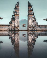 Man jumping amidst religious buildings 