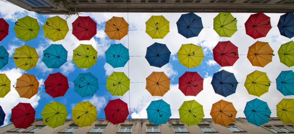 Full frame shot of multi colored umbrellas against sky