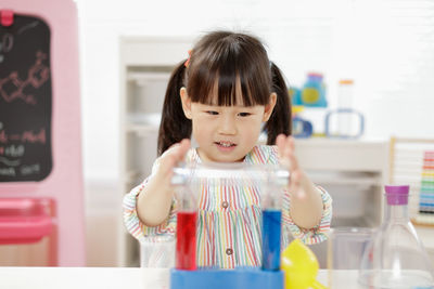 Portrait of cute girl looking at home