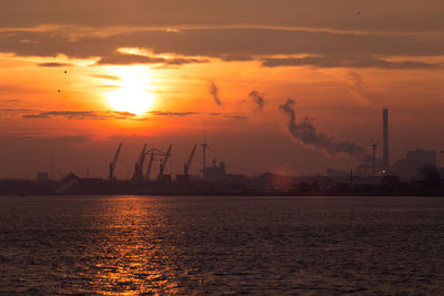 Scenic view of sea against orange sky