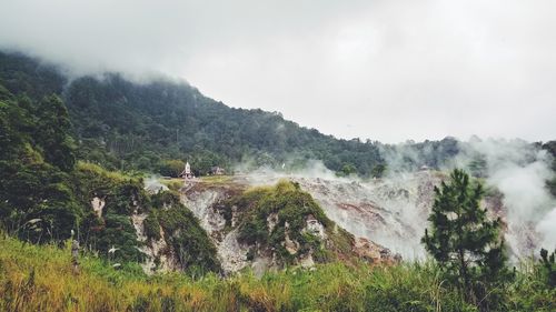 Scenic view of waterfall against sky