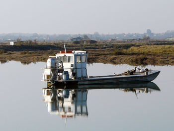 Boat on lake against clear sky