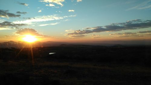 Scenic view of field against sky during sunset