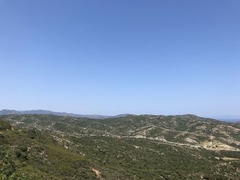 Scenic view of mountains against clear blue sky