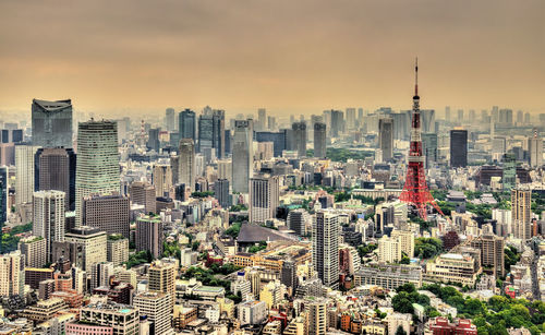 Aerial view of modern buildings in city against sky