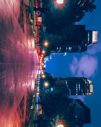 Illuminated buildings against sky at night