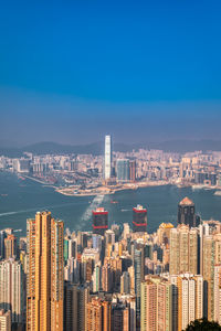 Modern buildings in city against blue sky