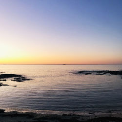 Scenic view of sea against clear sky during sunset