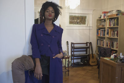 A young woman posing in a purple coat