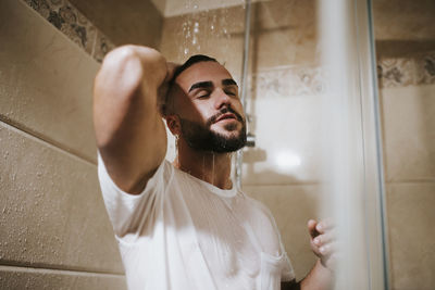 Midsection of man looking at camera