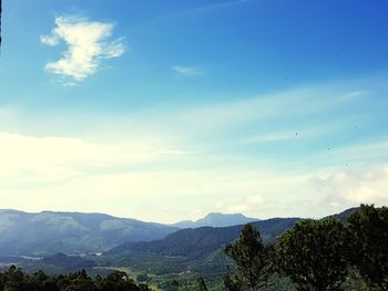 Scenic view of mountains against blue sky