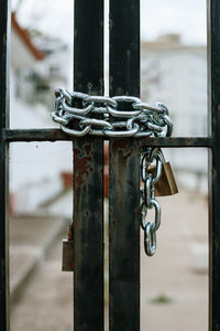 Close-up of padlock and chain on metal gate