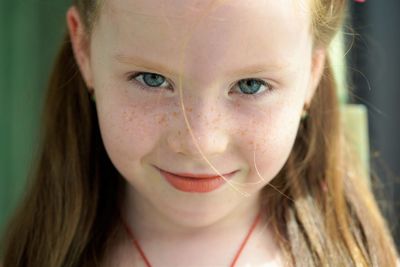 Portrait of young red hair girl looking at camera