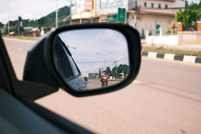 Reflection of car on side-view mirror