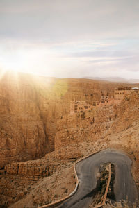 Road leading towards mountains against sky