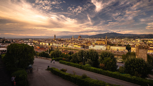 High angle view of road by buildings against sky during sunset