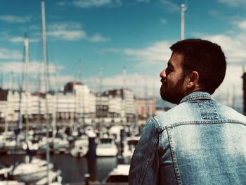 Young man looking away in city