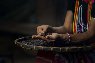 Hill tribe women sorting coffee beans. woman selecting roasted coffee bean. thailand.