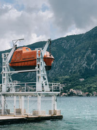 Ship in sea against mountain