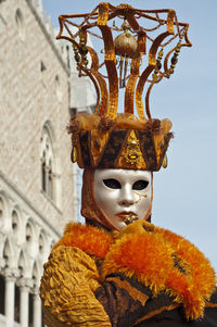 Portrait of person wearing mask against sky during carnival