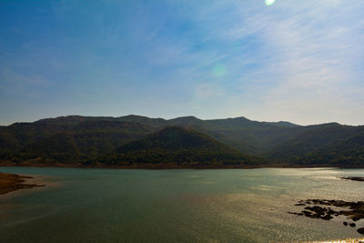 Scenic view of landscape and mountains against sky