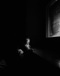 Boy by window in room at home